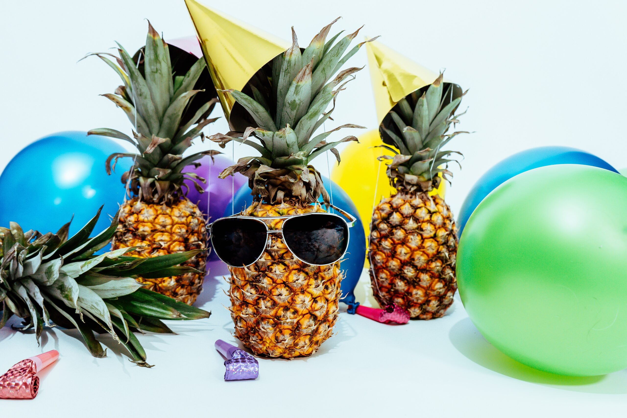 photo-of-three-pineapples-surrounded-by-balloons-1071882